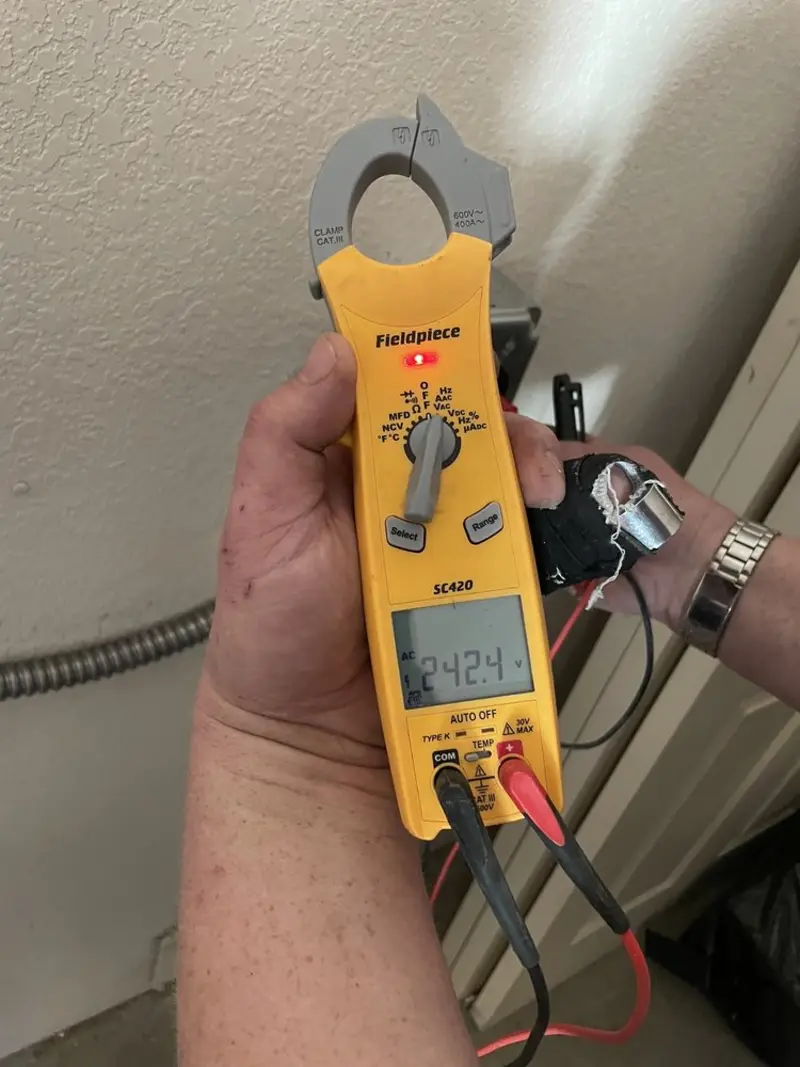 Voltage testing with clamp meter during Recessed Lighting Installation in Newport